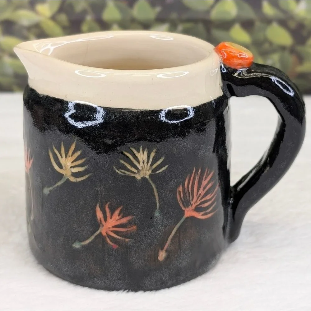 Handcrafted Black Ceramic Pitcher with Floral Design